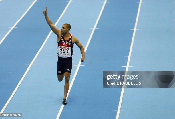 British Jason Gardener celebrates with his national flag after winning the 60m final, 04 March 2007 during the 29th European Athletics Indoor...