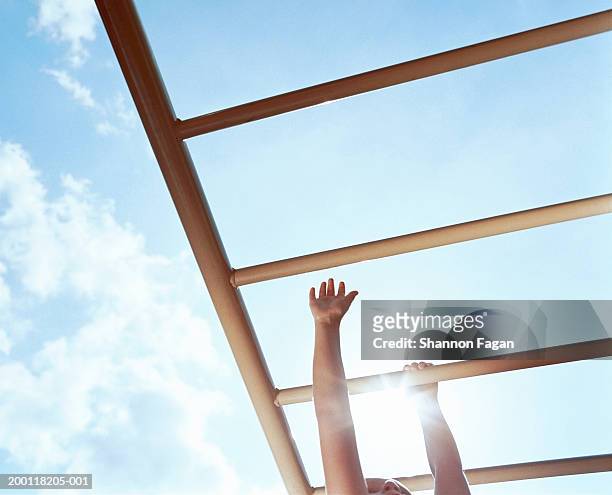 boy (4-6) on monkey bars, low angle view - monkey bars stock pictures, royalty-free photos & images