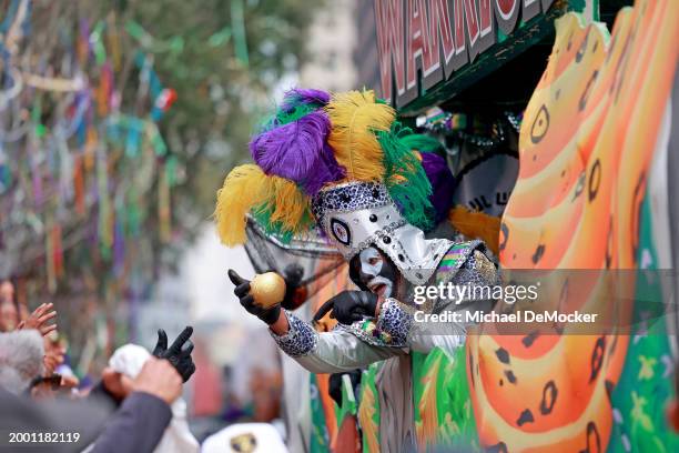 Rider teases the crowd with a coconut as the over 1,100 riders of the Krewe of Zulu make their way down St. Charles Avenue on Mardi Gras Day with...