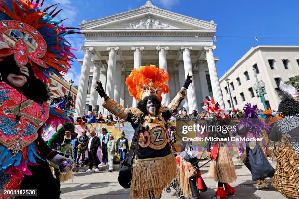 The Zulu Walking Warriors pass in front of Gallier Hall as the over 1,100 riders of the Krewe of Zulu make their way down St. Charles Avenue on Mardi...