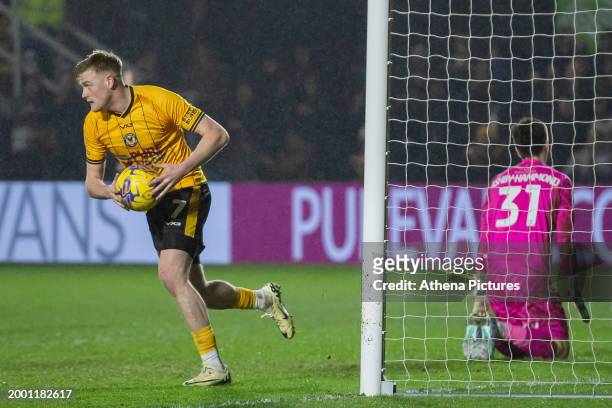 Will Evans of Newport County grabs the ball after scoring a penalty during the Sky Bet League Two match between Newport County and Notts County at...