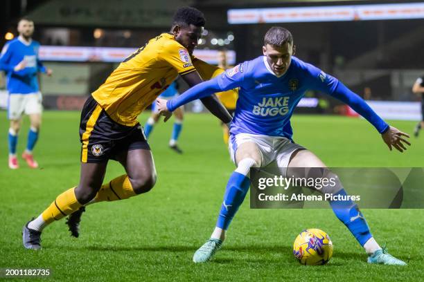 Aden Baldwin of Notts County blocks Offrande Zanzala of Newport County from getting to the ball during the Sky Bet League Two match between Newport...