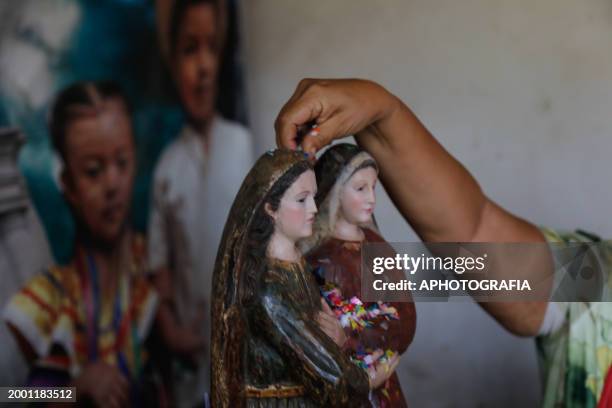 Woman throws an eggshell filled with confetti to ask permission at the altar of the Virgin Mary and Elizabeth during the celebration of 'Fiesta de...