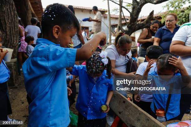 Children throw confetti-stuffed eggshells at each other's heads during the celebration of 'Fiesta de las Comadres', also known as 'Martes de...