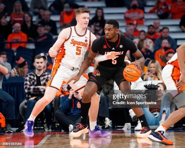 Louisvilie Cardinals Forward Brandon Huntley-Harfield dribbles the ball against Syracuse Orange Guard Justin Taylor during the second half of the...