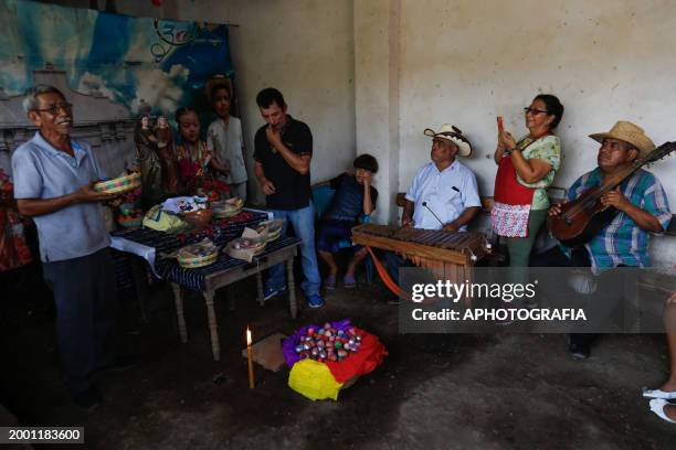 Indigenous leader speaks with members of the musical band during the celebration of 'Fiesta de las Comadres', also known as 'Martes de Carnaval' in...
