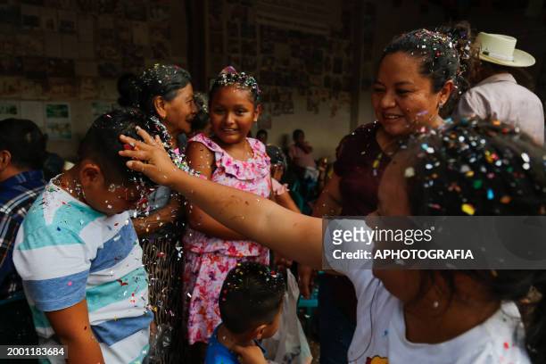 Children throw confetti-stuffed eggshells at each other's heads during the celebration of 'Fiesta de las Comadres', also known as 'Martes de...