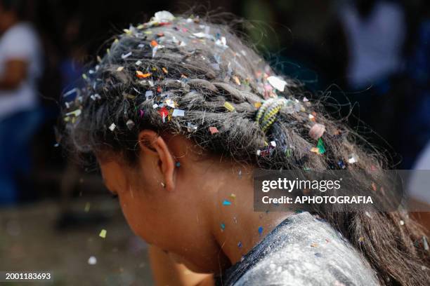 Detailed view of a girl's hair full of confetti during the celebration of 'Fiesta de las Comadres', also known as 'Martes de Carnaval' in Izalco on...