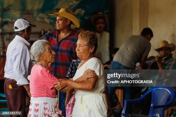 Women and men dance to bond the friendship or "compadrazgo" during the celebration of 'Fiesta de las Comadres', also known as 'Martes de Carnaval' in...