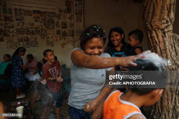 Children throw confetti-stuffed eggshells at each other's heads during the celebration of 'Fiesta de las Comadres', also known as 'Martes de...