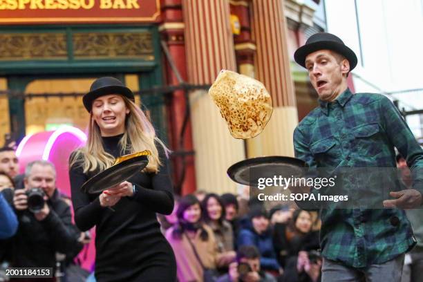 Participants take part in the annual Shrove pancake day race at Leadenhall market in central London. Hosted by the market's 18th century pub, The...