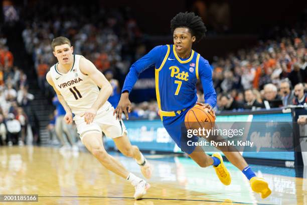 Carlton Carrington of the Pittsburgh Panthers drives past Isaac McKneely of the Virginia Cavaliers in the first half at John Paul Jones Arena on...