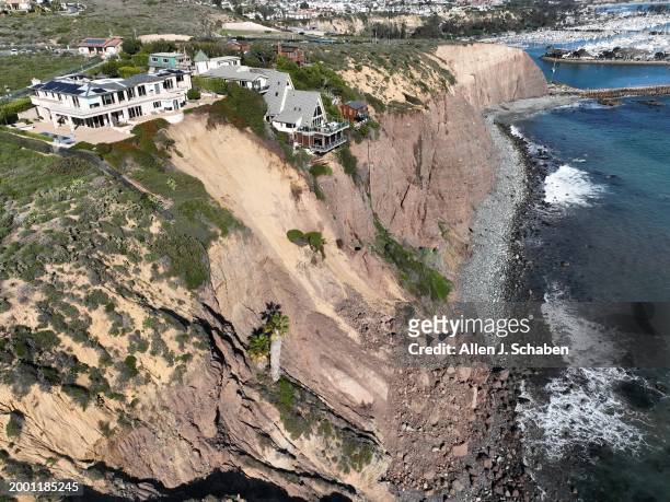 Dana Point, CA An aerial view of three large homes in Dana Point are in danger of falling into the ocean after a cliffside gave way over the weekend...