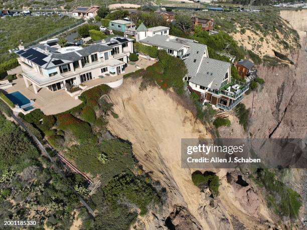 Dana Point, CA An aerial view of three large homes in Dana Point are in danger of falling into the ocean after a cliffside gave way over the weekend...