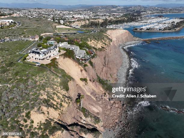 Dana Point, CA An aerial view of three large homes in Dana Point are in danger of falling into the ocean after a cliffside gave way over the weekend...