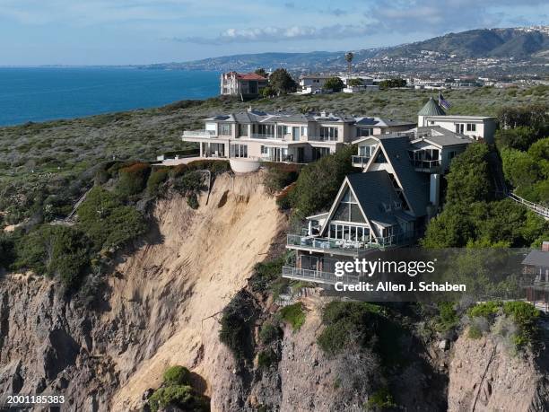 Dana Point, CA An aerial view of three large homes in Dana Point are in danger of falling into the ocean after a cliffside gave way over the weekend...