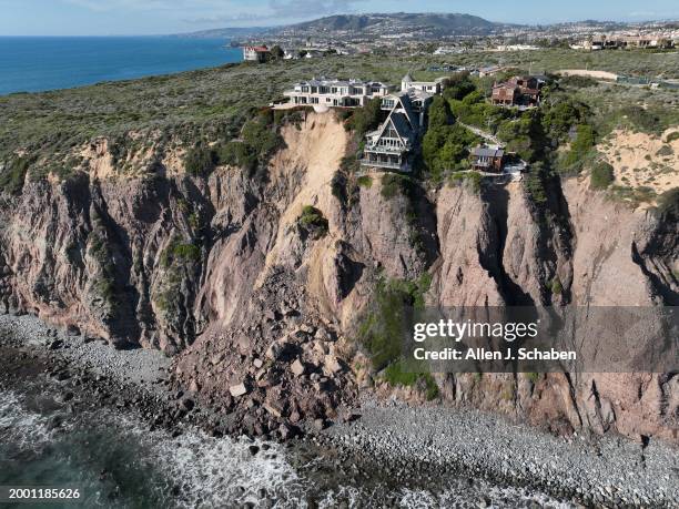 Dana Point, CA An aerial view of three large homes in Dana Point are in danger of falling into the ocean after a cliffside gave way over the weekend...