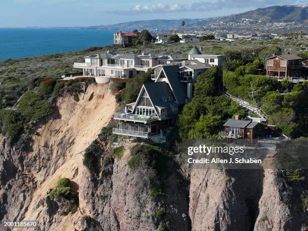 Dana Point, CA An aerial view of three large homes in Dana Point are in danger of falling into the ocean after a cliffside gave way over the weekend...