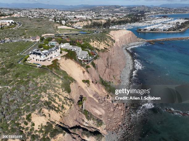 Dana Point, CA An aerial view of three large homes in Dana Point are in danger of falling into the ocean after a cliffside gave way over the weekend...