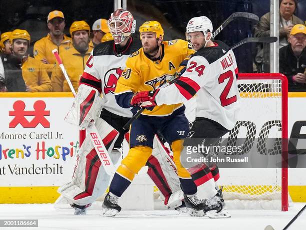 Ryan O'Reilly of the Nashville Predators battles in front of the net against Colin Miller and Nico Daws of the New Jersey Devils during an NHL game...