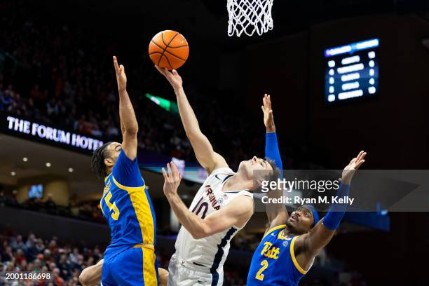 Taine Murray of the Virginia Cavaliers puts up a shot between Ishmael Leggett and Blake Hinson of the Pittsburgh Panthers in the second half at John...