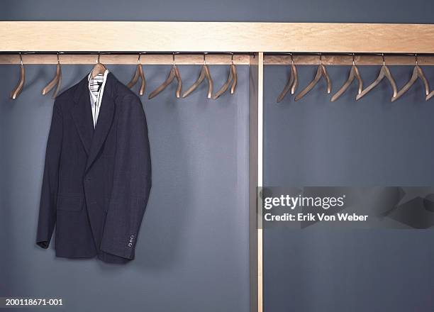 suit jacket and shirt hanging in office cubby - coathanger foto e immagini stock