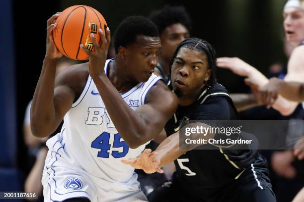 Fousseyni Traore of the Brigham Young Cougars is pressured by Omar Payne of the University of Central Florida Knights during the first half of their...