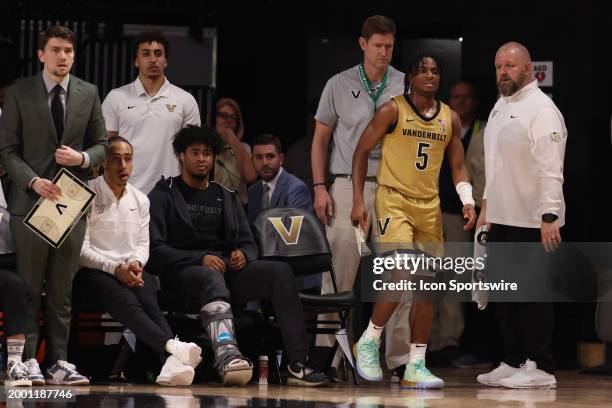 Vanderbilt Commodores guard Ezra Manjon is checked by medical staff after suffering an ankle injury during a game between the Vanderbilt Commodores...