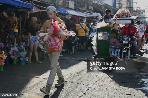 Man holding a bouquet of flowers at a flower market in Manila on February 14 in celebration of Valentine's Day.