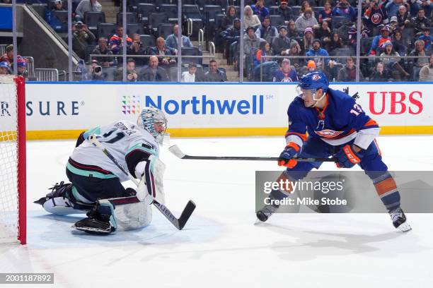 Philipp Grubauer of the Seattle Kraken makes a save against Mathew Barzal of the New York Islanders to win the overtime shootout at UBS Arena on...