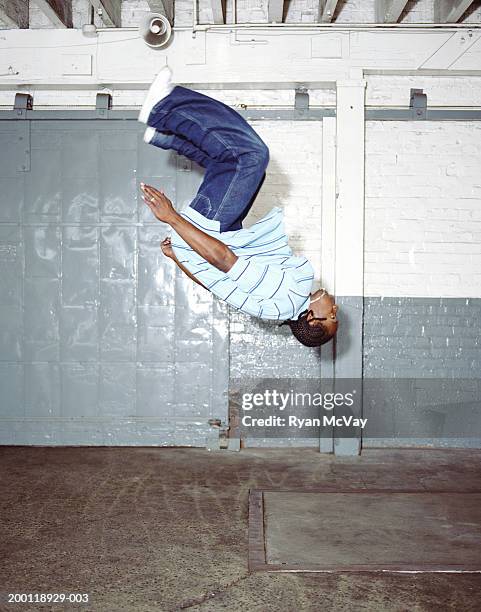 young male breakdancer doing backflip, side view - baggy jeans stock pictures, royalty-free photos & images