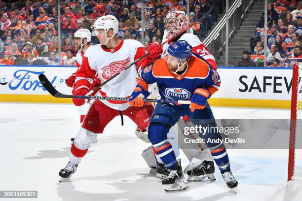 Connor Brown of the Edmonton Oilers battles in the crease in front of the net of goaltender Alex Lyon of the Detroit Red Wings during the game at...