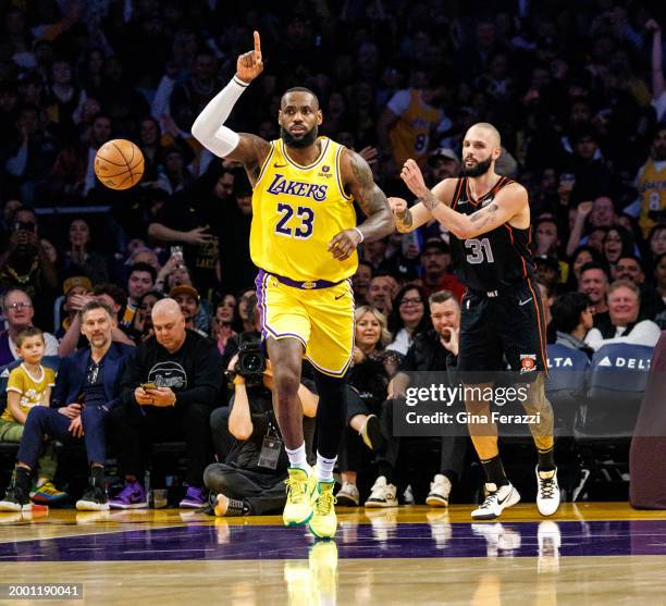 Los Angeles Lakers forward LeBron James reacts after scoring on a break away lay up against Detroit Pistons forward Evan Fournier in the fist half at...