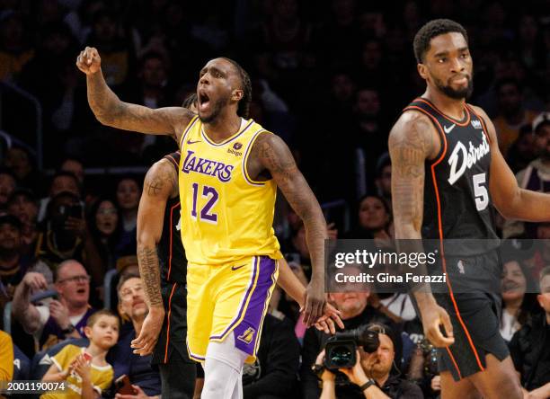 Los Angeles Lakers forward Taurean Prince reacts after being fouled while driving to the basket with Detroit Pistons guard Shake Milton on the right...