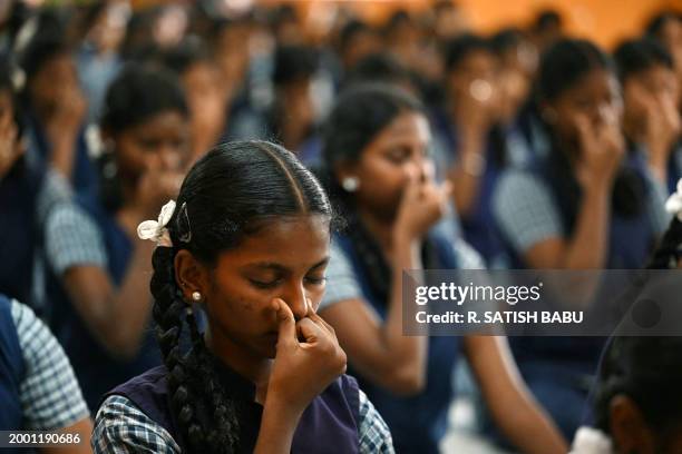 Students take part in a yoga session at a school ahead of their board examination in Chennai on February 14, 2024.