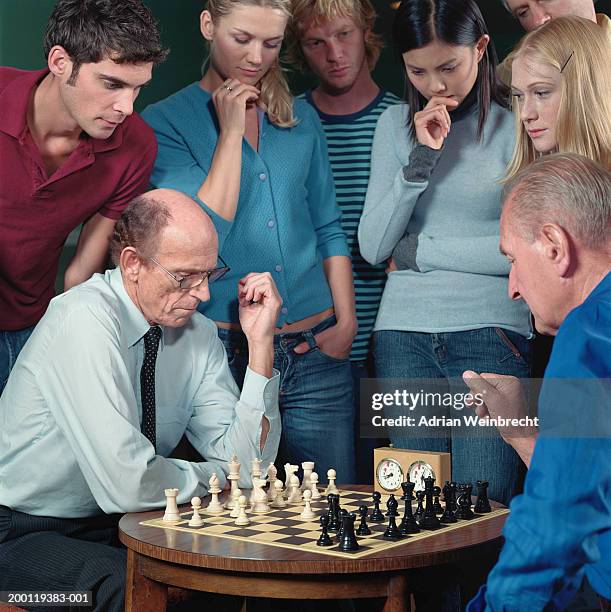 Grown men play chess using a watch to control time