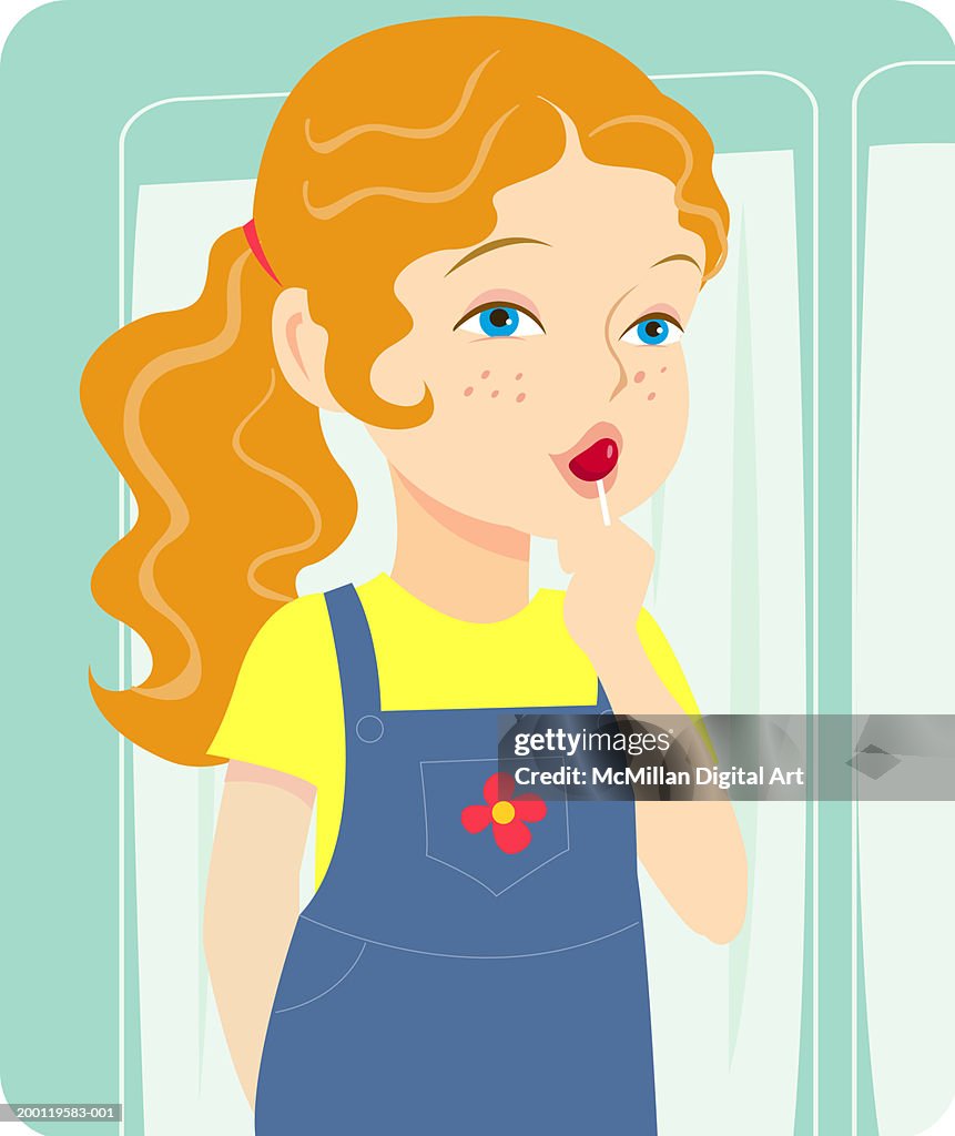 Young girl (3-5) sucking on candy