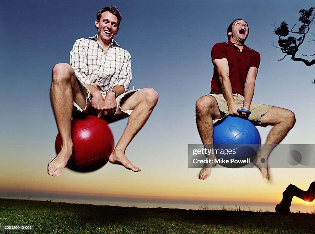 Two young men playing with bounce and hop balls
