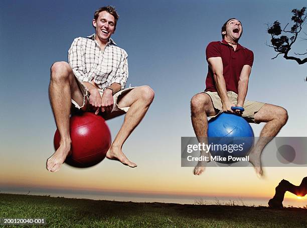 two young men playing with bounce and hop balls - 気が若い ストックフォトと画像