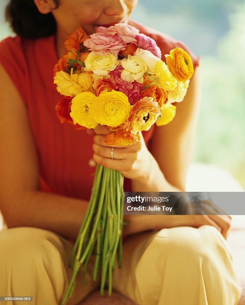 Woman holding bouquet of ranunculus