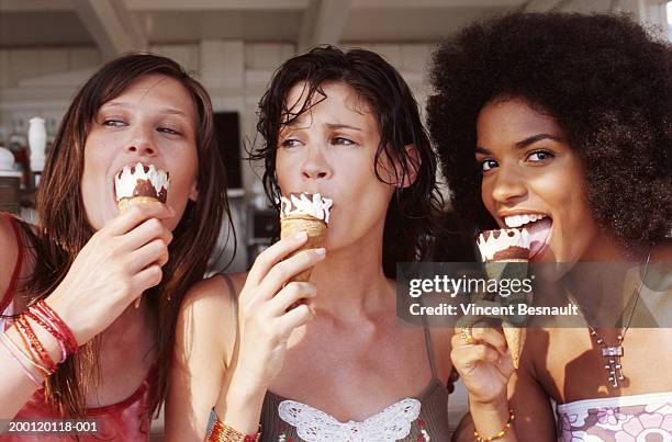 two young women and teenage girl (15-17) eating ice cream cones - girls licking girls fotografías e imágenes de stock