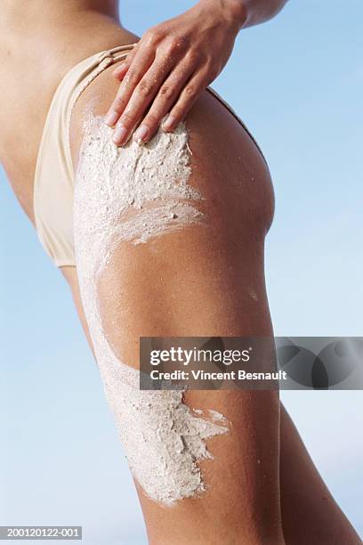 woman rubbing beauty scrub into leg, mid section - woman leg spread stock pictures, royalty-free photos & images