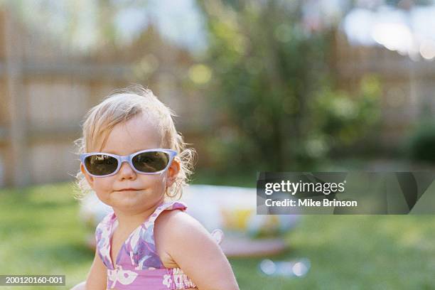 girl (15-18 months) wearing sunglasses, outdoors - baby attitude stock pictures, royalty-free photos & images