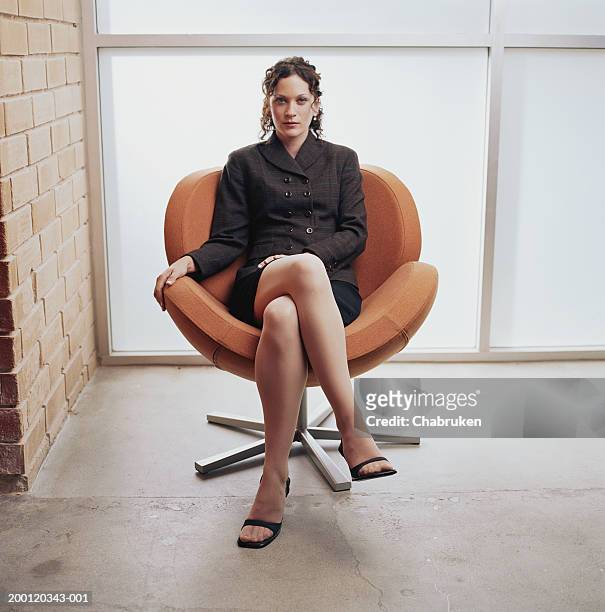 young business woman sitting in chair, portrait - legs crossed at knee stock pictures, royalty-free photos & images