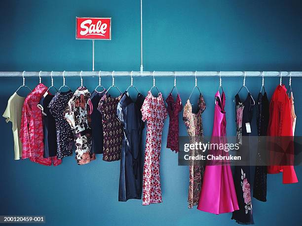 rack of  women's clothes with sale sign in store - clothes shop stock pictures, royalty-free photos & images