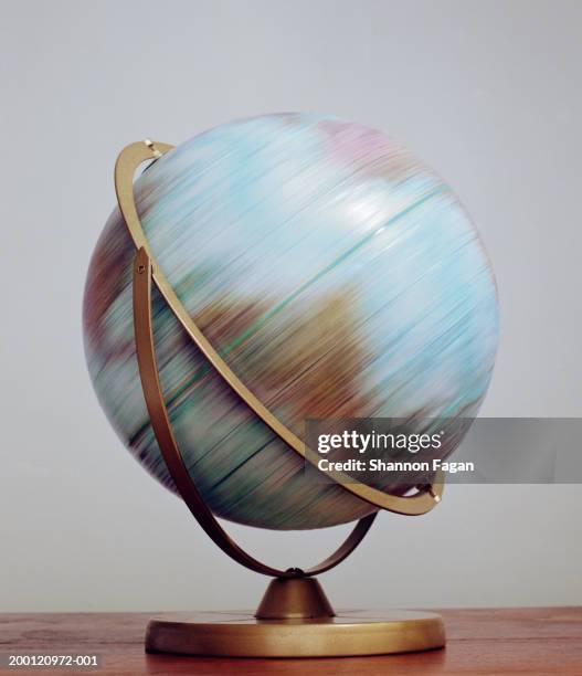 world globe spinning, close-up (blurred motion) - desktop globe stock pictures, royalty-free photos & images