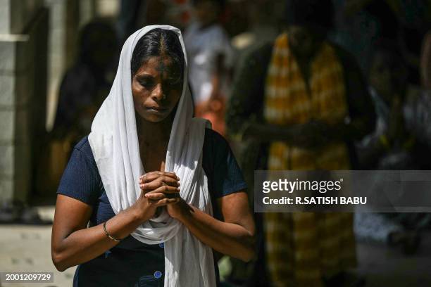 Christian devotees offer prayers during an Ash Wednesday mass service at St. Thomas Cathedral Basilica in Chennai on February 14, 2024.