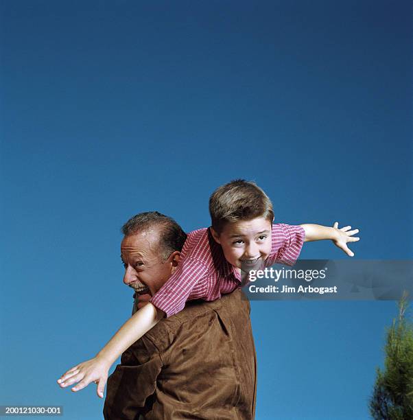 Boy Pretending To Fly While Grandfather Holds Him Over Shoulder High-Res  Stock Photo - Getty Images