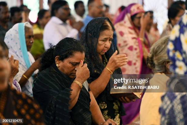 Christian devotees offer prayers during an Ash Wednesday mass service at St. Thomas Cathedral Basilica in Chennai on February 14, 2024.