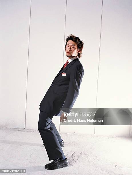 young businessman slouching, eyes closed, sideview - stoneplus1 stock pictures, royalty-free photos & images